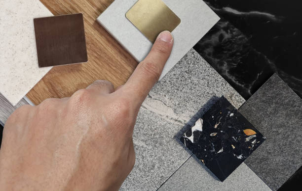 Hand pointing at a variety of flooring options and colors